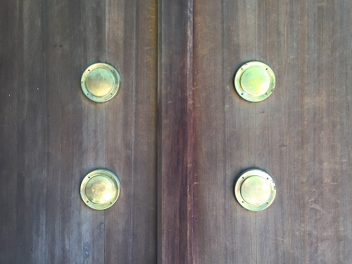 zoom up of brass decoration tacks on doors