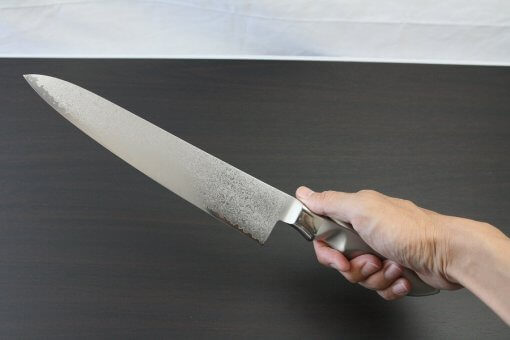 Japanese Chef Knife, Damascus Gyuto size L, grabbed by man's hand
