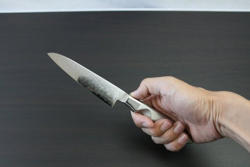 Japanese Chef Knife, Petit utility knife size 120mm, grabbed by a man's hand