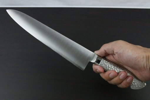 Japanese Chef Knife, Elegance Monaka Series, Gyuto chef knife 240mm, grabbed by a man's hand