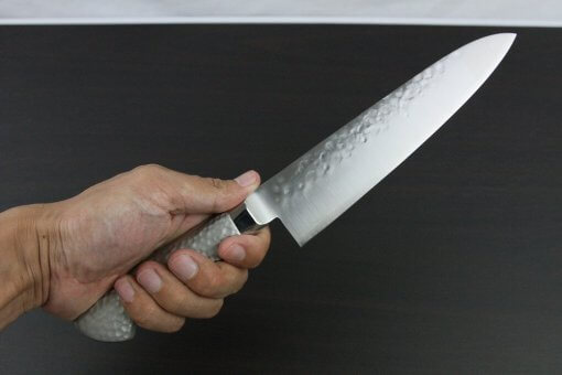 Japanese Chef Knife, Hammer Finish Series, Gyuto chef knife 180mm left-handed, grabbed by a man's hand