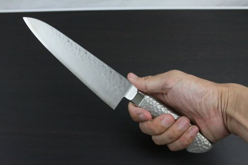 Japanese Chef Knife, Hammer Finish Series, Gyuto chef knife 180mm, grabbed by a man's hand
