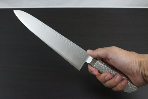 Japanese Chef Knife, Hammer Finish Series, Gyuto chef knife 240mm, grabbed by a man's hand