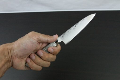 Japanese Chef Knife, Hammer Finish Series, Petit knife 120mm left-handed, grabbed by a man's hand