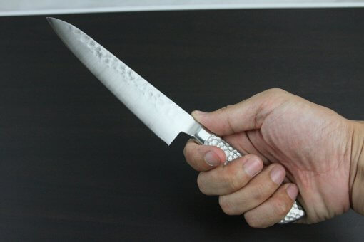 Japanese Chef Knife, Hammer Finish Series, Petit knife 150mm, grabbed by a man's hand