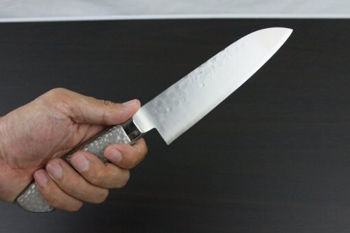 Japanese Chef Knife, Hammer Finish Series, Santoku multi-purpose knife 150mm left-handed, grabbed by a man's hand