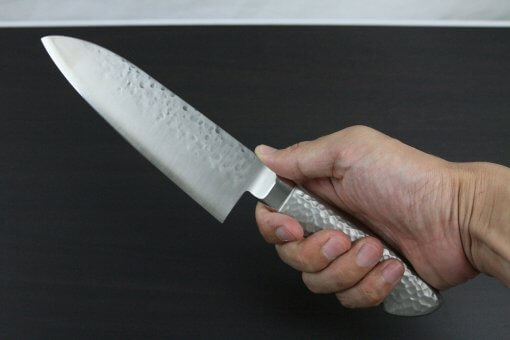 Japanese Chef Knife, Hammer Finish Series, Santoku multi-purpose 165mm, grabbed by a man's hand