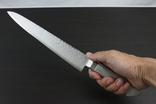 Japanese Chef Knife, Hammer Finish Series, Sujihiki Slicing Knife 240mm, grabbed by a man's hand