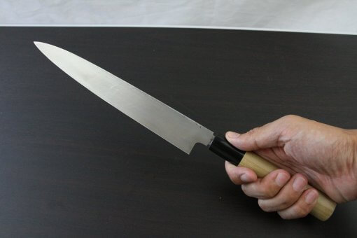 Japanese professional chef knife, Yanagiba Sushi knife, 1st grade 240mm, grabbed by a man's hand