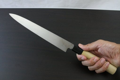 Japanese professional chef knife, Yanagiba Sushi knife, 1st grade 270mm, grabbed by a man's hand