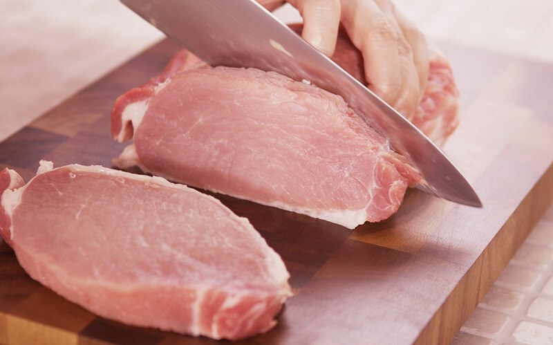 Japanese Chef’s Knives (Gyuto) and Kitchen Knives (Santoku), someone is cutting large chunk of meat with Gyuto