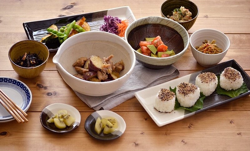 foods are served in a japanese style dishes and bowls