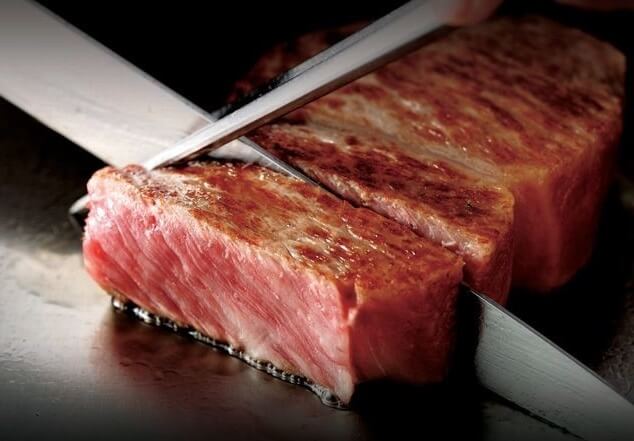 Wagyu Japanese beef, an excellent Japanese cuisine, cutting by knife