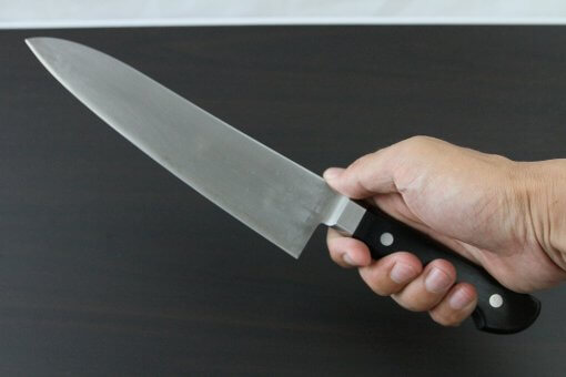 Japanese Chef Knife, Toshu super blue steel Aogami Super, Gyuto chef knife 210mm, grabbed by a man's hand