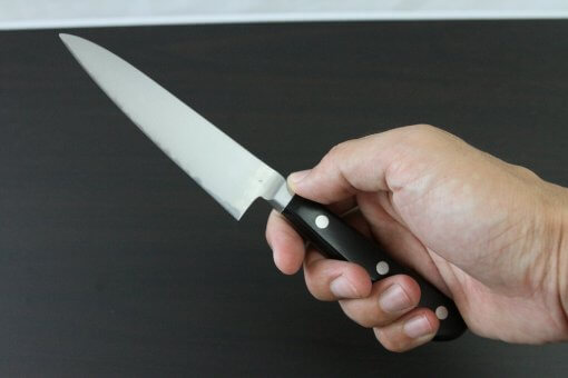 Japanese Chef Knife, Toshu super blue steel Aogami Super, petit knife 120mm, grabbed by a man's hand