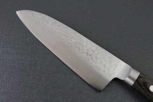 Toshu Santoku multi-purpose Japanese chef's knife, hammered finish blade and gray handle, details of blade backside
