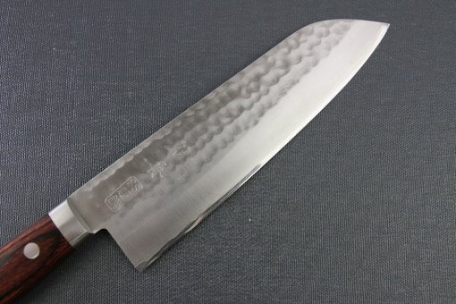 Toshu Santoku multi-purpose Japanese chef's knife, hammered finish blade and mahogany handle, details of blade front side