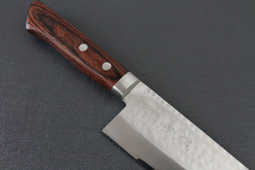 Toshu Santoku multi-purpose Japanese chef's knife, hammered finish blade and mahogany handle, diagonal front view