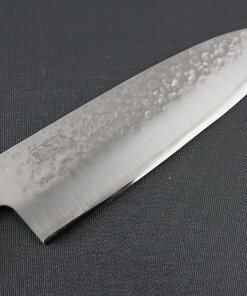 Toshu Santoku multi-purpose Japanese chef's knife, hammered finish blade and red handle, details of blade front side