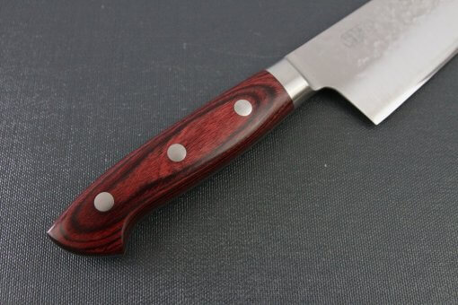 Toshu Santoku multi-purpose Japanese chef's knife, hammered finish blade and red handle, details of red wood handle