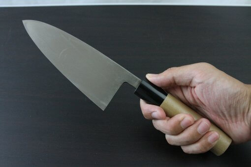 Japanese professional chef knife, Deba fillet knife, stainless steel 150mm, grabbed by a man's hand