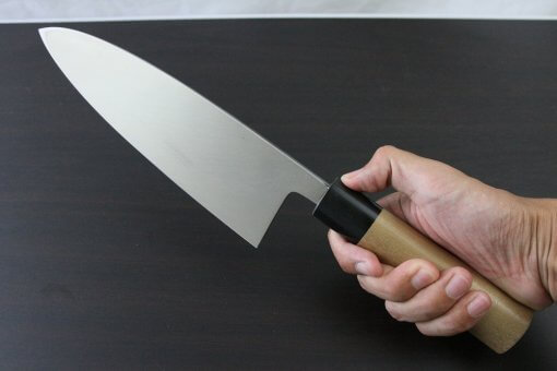 Japanese professional chef knife, Deba fillet knife, stainless steel 210mm, grabbed by a man's hand