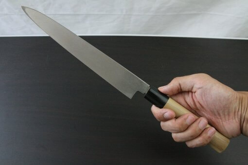 Japanese professional chef knife, Yanagiba Sushi knife, stainless steel 240mm, grabbed by a man's hand
