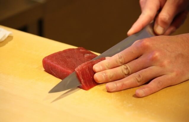 cut tuna by a Japanese sushi knife