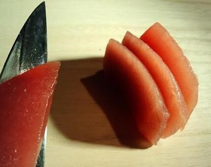 cut tuna sashimi by a Japanese sushi knife