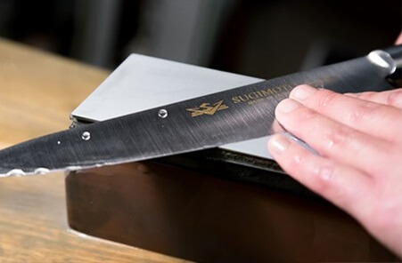 sharpening Japanese knife by a professional chef
