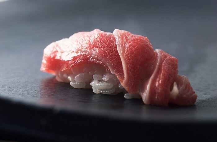 Fatty tuna on a black plate