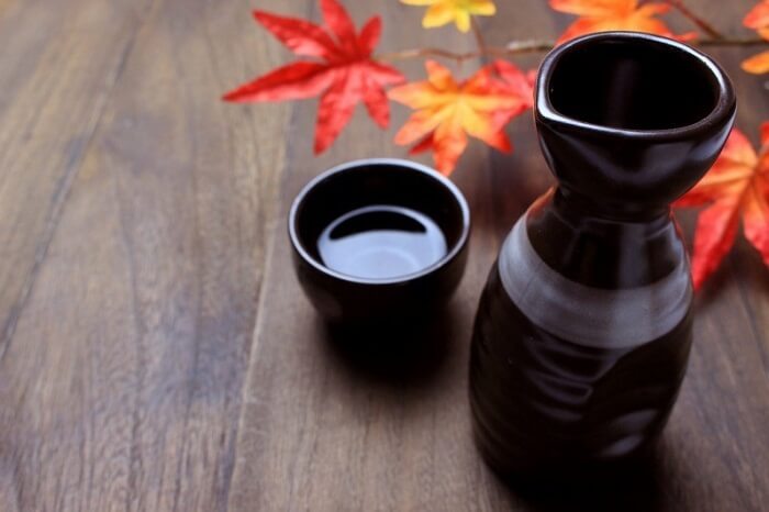 Japanese Sake in a cup and bottle