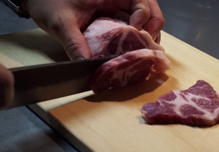 Sharpest Japanese chef knives, cutting meat chunk