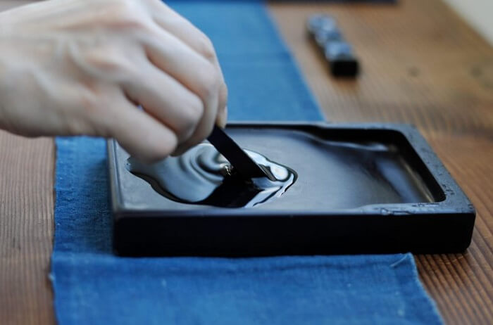 dissolving sumi ink on suzuri for Shodo calligraphy writing